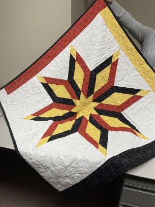 Donna Burnam handmade the two medicine wheel inspired lap-sized star quilts that people have the chance to win if they purchase raffle tickets. One ticket is $10 or three is $20. Courtesy photo
