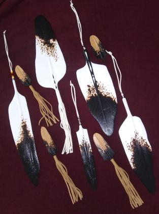 Yannott shares his art through various mediums including canvas, pen and pencil drawings, regalia, sculpture, birch bark and quillwork. Pictured here are hand painted carved cedar feathers often used for car mirrors and hung up on walls in homes.  Courtesy photo