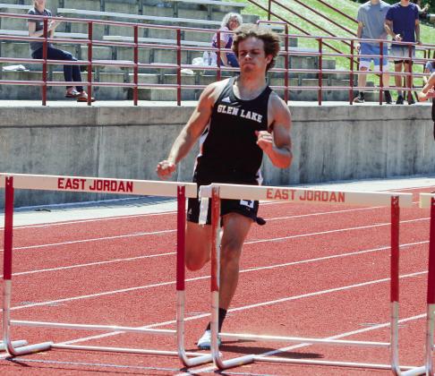 Glen Lake senior Tyler Bixby dig deep in the 300-meter hurdles to qualify for states.