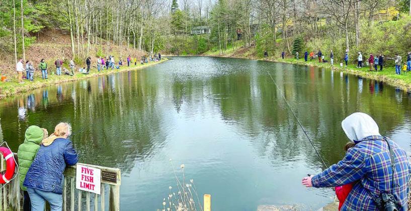 People line around the Mill Pond to try their hand at catching rainbow trout stocked by the Northport Sportman’s Club.