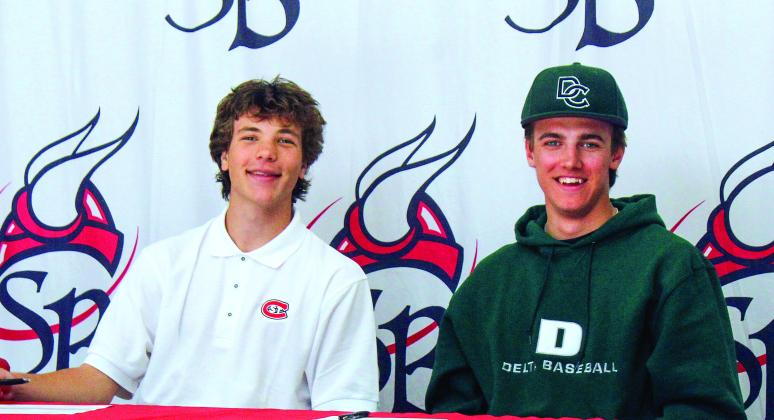 Suttons Bay seniors Finn Mankowski (left) and Lucas Gordon (right) sign their letter-of-intent to play soccer and baseball at St. Cloud State University (Minnesota) and Delta College last week. Enterprise photo by Brian Freiberger