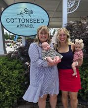Cottonseed Apparel owners Lizzie Gray (left) and her son, Rory, and Laurenn Rudd (right) with her daughter, Quinn Ankerson, are pictured at the store in Glen Arbor last week. The two business partners became pregnant around the same time and have been bringing their babies into work since they returned from maternity leave recently. Courtesy photo